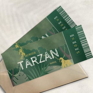 May include: Two green Tarzan musical tickets with white text and a jungle design, including a gorilla silhouette. The tickets are inside a brown envelope. The tickets show the block, row, and seat number.