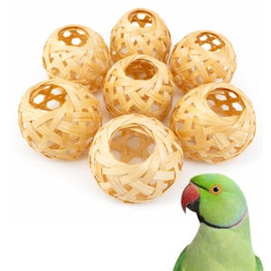 May include: Seven woven bamboo balls with open centers, arranged in a circular pattern. The balls are a light tan color. A green parrot with a red beak is in the lower right corner.