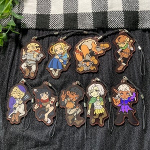 May include: Set of ten colorful cartoon character keychains. Each keychain features a different character with unique details and expressions. The keychains are made of durable plastic and are perfect for adding a touch of whimsy to your keys or bag.