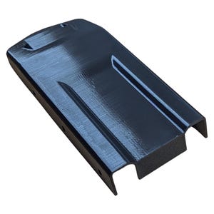 May include: A black, rectangular object with a textured surface. The object has a curved top and a recessed channel running along its length. The ends are cut out, and it appears to be made of a rigid material.
