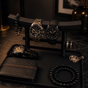 May include: A black torii-shaped watch and jewelry stand holding two wristwatches and a beaded bracelet. The base tray contains a black wallet, a skeleton watch, a gold-toned pendant necklace, a black beaded necklace, and a ring.