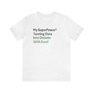 May include: White t-shirt with the text "My SuperPower? Turning Data Into Dreams With Excel" in black and green. The shirt has short sleeves and a crew neck.
