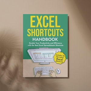 May include: A green book cover with the title "EXCEL SHORTCUTS HANDBOOK" in yellow text. The subtitle is "Double Your Productivity and Efficiency with the Best Excel Spreadsheets Shortcuts". An illustration of a computer monitor, keyboard, and mouse is shown. A yellow speech bubble says "Includes All the Latest Excel Shortcuts".