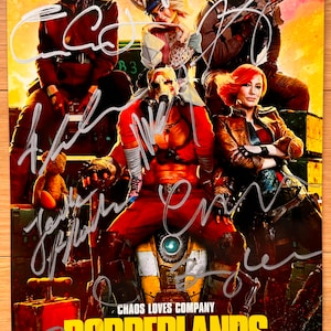 May include: A movie poster for the film Borderlands, featuring a cast of actors including Cate Blanchett and Kevin Hart. The poster has a vibrant color scheme with the film's title in large yellow letters. The actors' signatures are visible.
