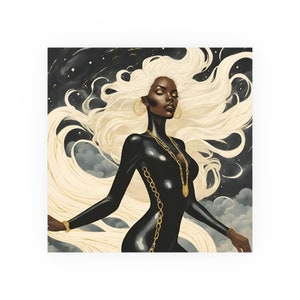 May include: An artistic print depicting a woman with flowing blonde hair and dark skin, adorned with gold jewellery. She wears a black bodysuit with gold chain accents, set against a backdrop of a starry sky and clouds.