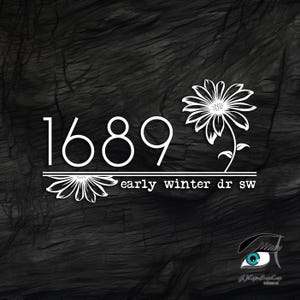 May include: A black and white image of a house number sign with the number 1689 and the text "early winter dr sw" below it. The sign is decorated with two white stylized daisy flowers.