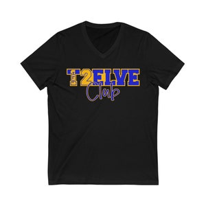 May include: Black v-neck t-shirt with a blue and gold graphic that says "T2ELVE Club".