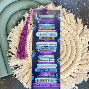May include: A purple and black bookmark with a tassel. The bookmark features a stack of books with the text "Barbarian's Seduction" on the bottom book. The text on the other books includes "Barbarian's Bride", "Barbarian's Treasure", "Barbarian's Valentine", "Barbarian's Beloved", "Barbarian's Tease", "Barbarian's Rescue", "Barbarian's Lady", "Barbarian's Redemption", "Barbarian's Choice", "Barbarian's Hope", "Barbarian's Heart", "Barbarian's Taming", "Barbarian's Touch", "Barbarian's Mate", "Barbarian's Prize", "Barbarian Mine", "Barbarian Alien", "Endirian Love", and "Ice Planet Barbarians".