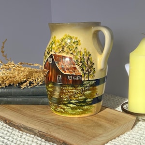 May include: A set of three ceramic mugs with a speckled, matte finish. The mugs are in shades of cream, light gray, and dark gray. Each mug has a simple, minimalist design, perfect for coffee or tea.