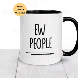 May include: White ceramic mug with a black rim and handle. The mug has the text "EW PEOPLE" printed in black on the front.