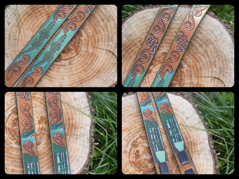 May include: Two leather straps with intricate carvings of swirling patterns and green and blue accents. The straps are laid out on a wooden surface.