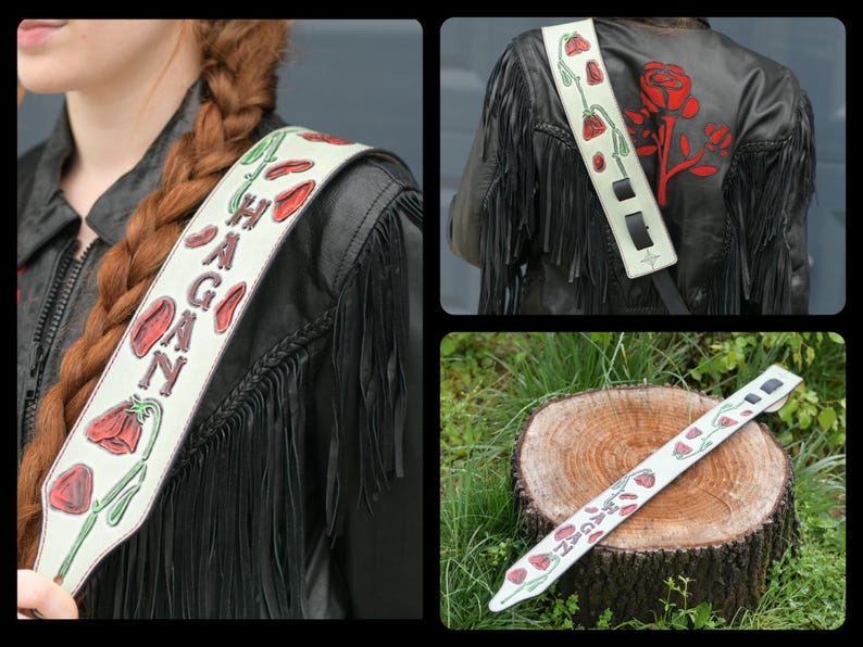 May include: White leather guitar strap with red and green floral designs and the name "HAGAN" written in black.