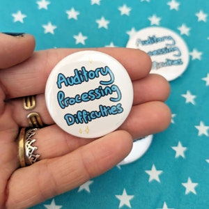 May include: A white button with blue text that reads "Auditory Processing Difficulties".