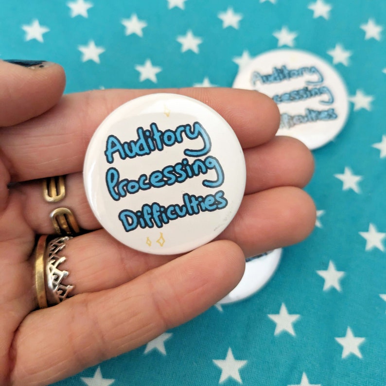 May include: A white button with blue text that reads "Auditory Processing Difficulties".