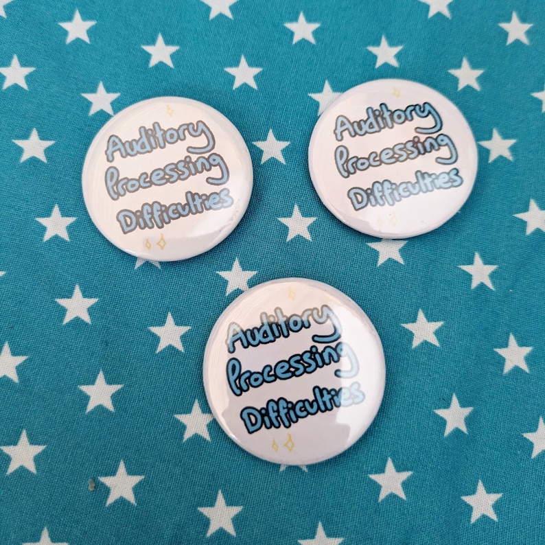 May include: Three white button badges with blue text that reads "Auditory Processing Difficulties". The badges are on a blue background with white stars.