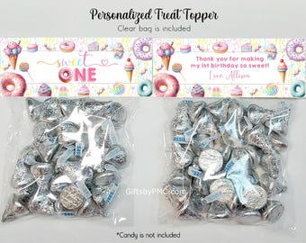 May include: Clear cellophane bags filled with silver-wrapped chocolate candies, topped with a decorative banner. The banner reads "Sweet One" and "Thank you for making my 1st birthday so sweet! Love Allison."