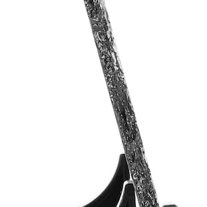 May include: A black slate picture frame with a natural, rough texture. The frame is standing on a black plastic stand with two legs.