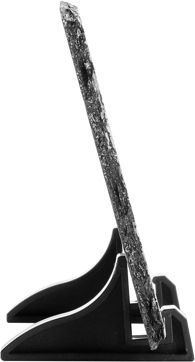 May include: A black slate picture frame with a natural, rough texture. The frame is standing on a black plastic stand with two legs.