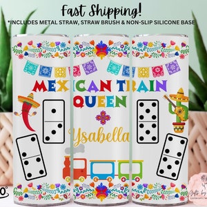 May include: A white tumbler with a colorful Mexican Train design. The tumbler features a train, dominoes, and the text "Mexican Train Queen Ysabella".