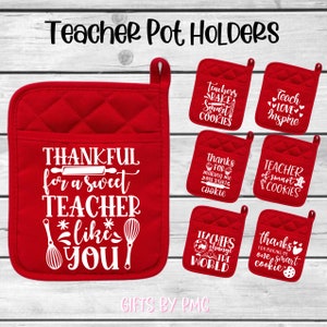May include: Set of six red quilted pot holders with white text. The pot holders feature various teacher-themed sayings, including "Thankful for a sweet teacher like you", "Teachers bake smart cookies", "Teach love inspire", "Thanks for making me one smart cookie", "Teacher of smart cookies", and "Teachers change the world".