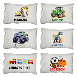 May include: Six personalized pillowcases with different designs for children. The pillowcases feature a yellow excavator, a green tractor, a green monster truck, a blue dinosaur, a colorful train, and a soccer ball, basketball, and football. The pillowcases are all white with black text.
