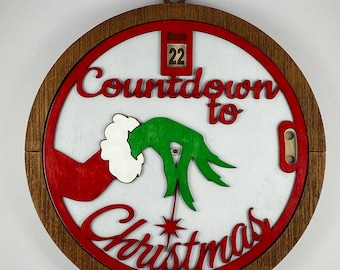 Percha de pared intercambiable de madera pintada a mano con cuenta regresiva del Grinch navideño.