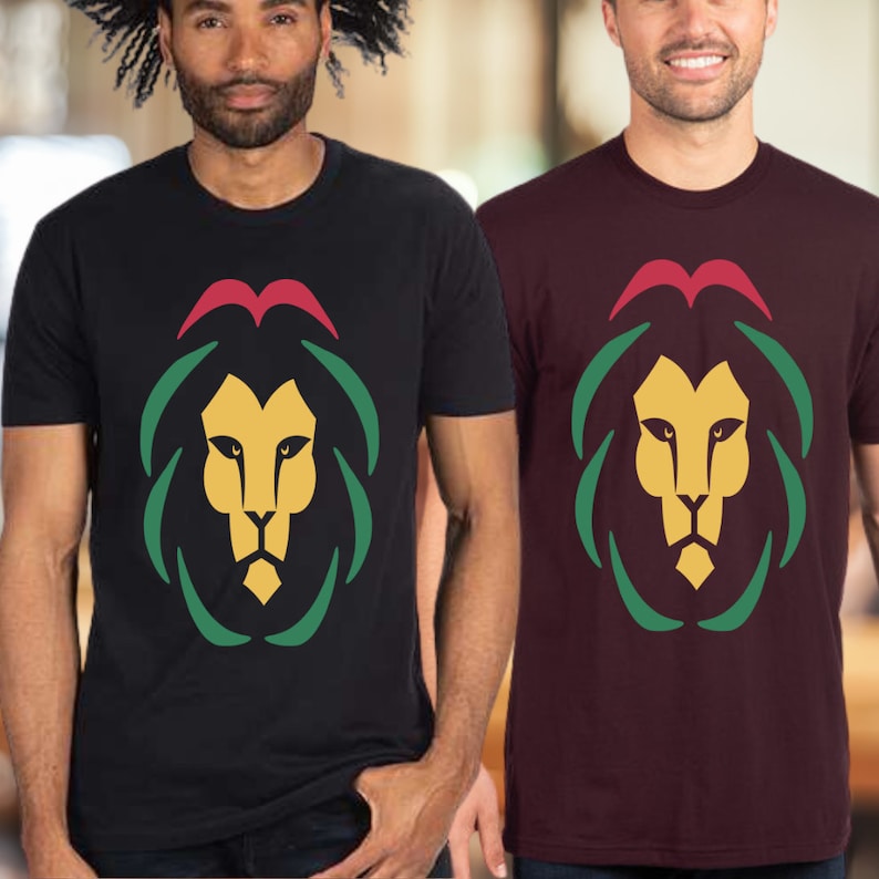May include: Two men wearing t-shirts with a lion graphic. The lion is stylized with a red, green, and yellow color scheme. One shirt is black and the other is maroon.
