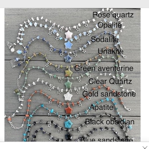 Könnte beinhalten: Neun Halsketten aus verschiedenen Steinsorten und silbernen Sternanhängern. Die Steine sind: Rosenquarz, Opalit, Sodalith, Unakit, grüner Aventurin, klarer Quarz, Goldsandstein, Apatit, schwarzer Obsidian und blauer Sandstein.