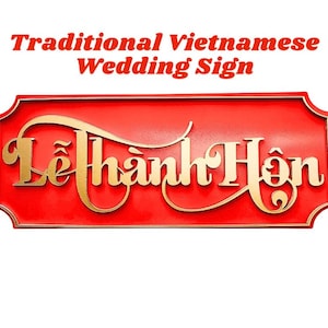 May include: A red rectangular sign with gold lettering that reads "Lễ thành hôn" in a stylized script. The text "Traditional Vietnamese Wedding Sign" is above the main text in red.