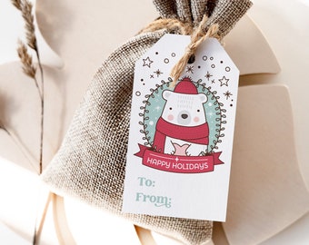 May include: A white gift bag with a brown burlap drawstring closure. A white gift tag with a cartoon polar bear wearing a red scarf and a red Santa hat is attached to the bag. The tag says "Happy Holidays" and has space to write "To:" and "From:".