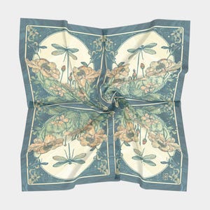 May include: A square scarf featuring a repeating pattern of dragonflies and flowers in shades of muted blue, cream, and soft peach. The design is divided into four symmetrical quadrants, each showcasing detailed botanical illustrations and insects.