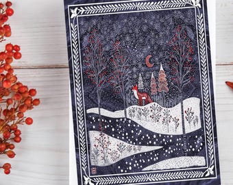 May include: A rectangular greeting card featuring a dark blue winter night scene with a red fox standing on a snowy hill. The illustration includes white trees, red berries, a crescent moon, and a decorative white border frame on a dark background.