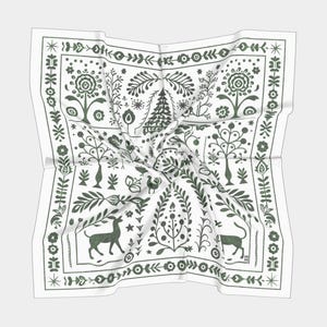 May include: A white square scarf with a green folk art design. The design features stylized trees, flowers, and animals. The scarf is folded and draped.