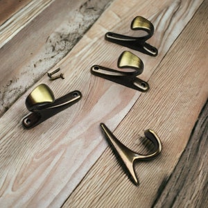 Unique Wall Hooks , Brass Hat Hooks, A Bronze-Colored Metal Clothes and Robe Hook With Modern Design