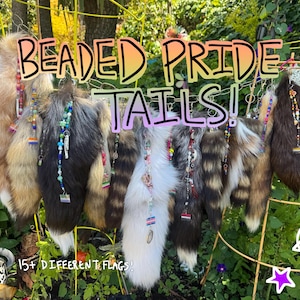 May include: A collection of faux fur tails in various colors including brown, white, gray, and black, each adorned with a hanging strand of colorful beads and a small pride flag charm. The text BEADED PRIDE TAILS! and 15+ DIFFERENT FLAGS! is visible.