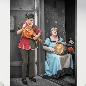 Women in Medieval Costume Playing Hurdy gurdy and Drum