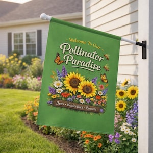 Puede incluir: Una bandera de jardín verde con el texto "Welcome To Our Pollinator Paradise". La bandera presenta ilustraciones de girasoles, mariposas, abejas y varias flores. También se incluyen las palabras "Bees, Butterflies, Blooms".