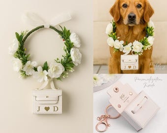 May include: A white leather mini purse with gold initials and a heart charm is attached to a floral wreath. The wreath is made of white flowers and green leaves. The purse is also shown on a dog.
