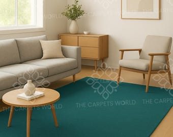Puede incluir: Alfombra rectangular de color verde azulado en un salón. La alfombra está colocada sobre un suelo de madera, con un sofá gris, una mesa de centro de madera y una obra de arte enmarcada en el fondo. La habitación está bien iluminada.