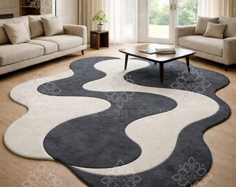 Abstrakter, handgetufteter Wollteppich mit Wellenmuster, moderner Teppich in unregelmäßiger Form, skulpturaler Teppich in Grau und Elfenbein, minimalistische Wohnzimmerdekoration