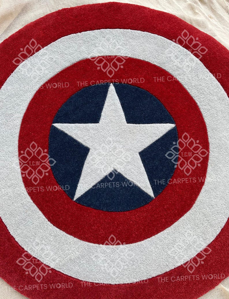 May include: A red, white, and blue circular rug with a white star in the center. The rug has the text "THE CARPETS WORLD" around the edge.