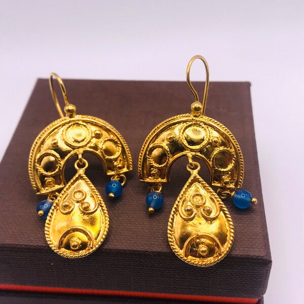 Chandelier pair of earrings made of yellow gold plated silver with blue beads.