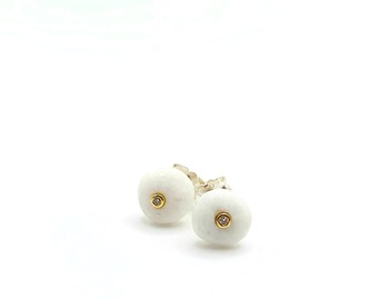 White pebble diamond stud earrings. Pebble stud earrings with white diamonds set on 14K yellow gold ana silver.