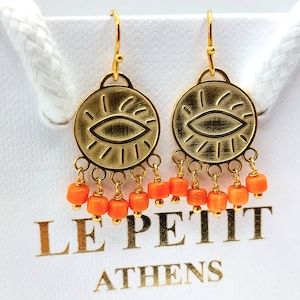 Evil Eye Coin earrings made in Greece.Evil Eye dangle earrings, made of yellow gold plated silver natural corals or turquoise beads.