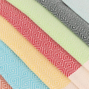 May include: A set of six Turkish towels in various colours, including turquoise, yellow, red, green, and black. The towels feature a diamond pattern and are made of cotton.