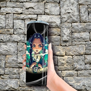 May include: A black and green stainless steel tumbler with a graphic of a cartoon girl holding a potion bottle. The text "Never Your Dead" is on the tumbler.