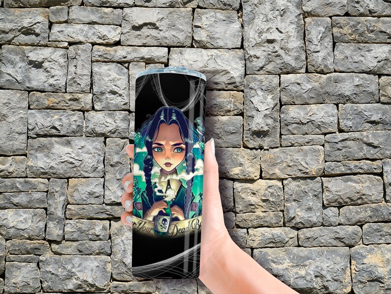 May include: A black and green stainless steel tumbler with a graphic of a cartoon girl holding a potion bottle. The text "Never Your Dead" is on the tumbler.