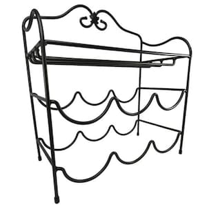 May include: Black metal wine rack with a decorative top and space for multiple bottles. The rack has a two-tiered design, with a top shelf and curved holders for wine bottles below. The rack is freestanding and suitable for home use.