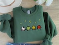 EMBROIDERED Stardew Valley Junimo Sweatshirt, Geek Chic Style, Cozy Gamer Fashion, Cozy Gamer Apparel, Gamer Fashion Must-Have