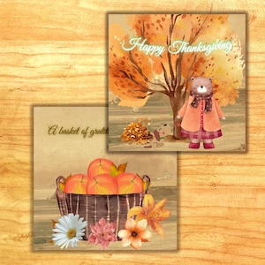 Peut inclure: Deux cartes carrées avec des illustrations à l'aquarelle. L'une représente un ours en manteau et écharpe avec le texte "Happy Thanksgiving" sur fond d'arbre d'automne. L'autre montre un panier de pommes avec des fleurs et le texte "A basket of gratitude".